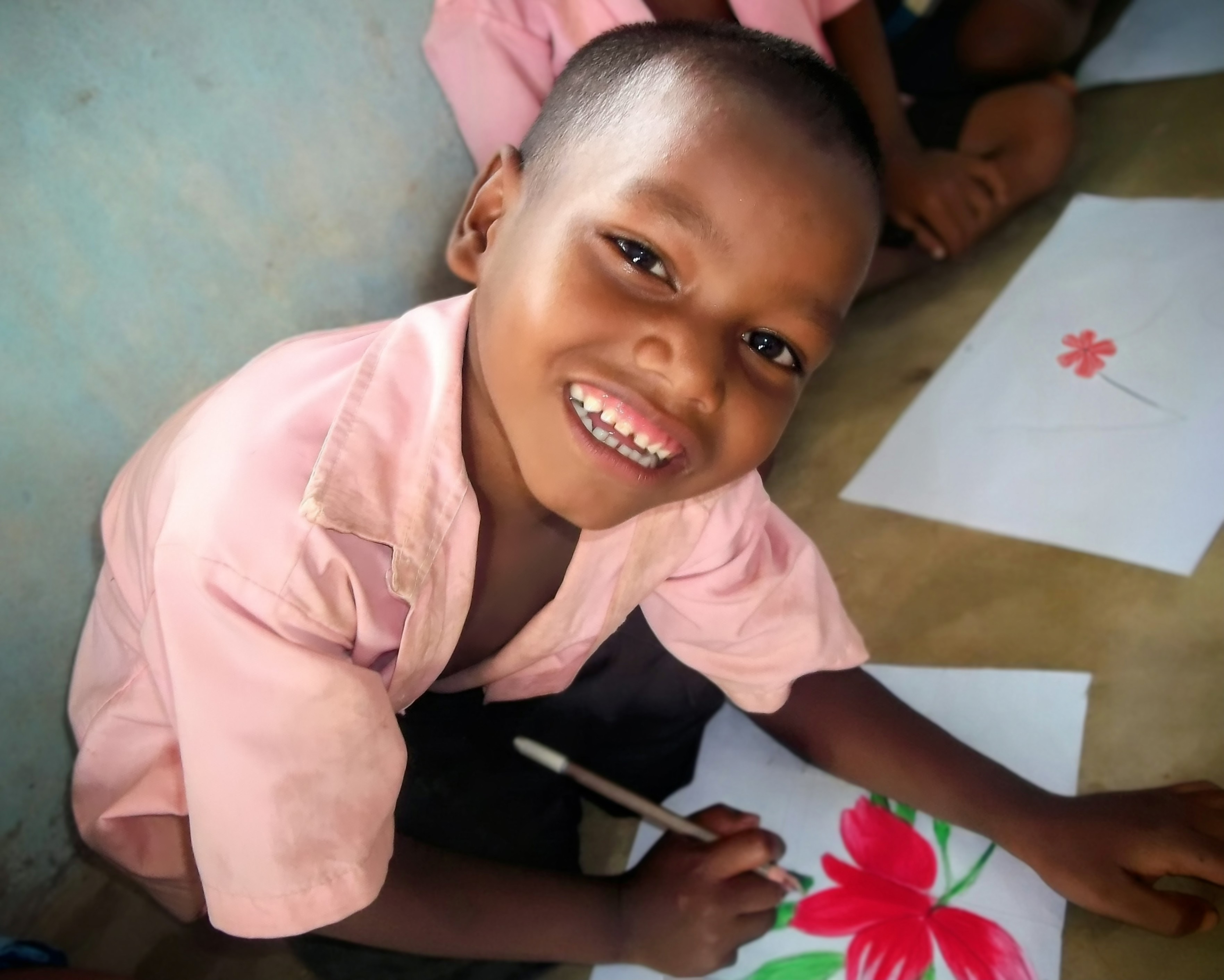 Smiling child learning — COSA community education program